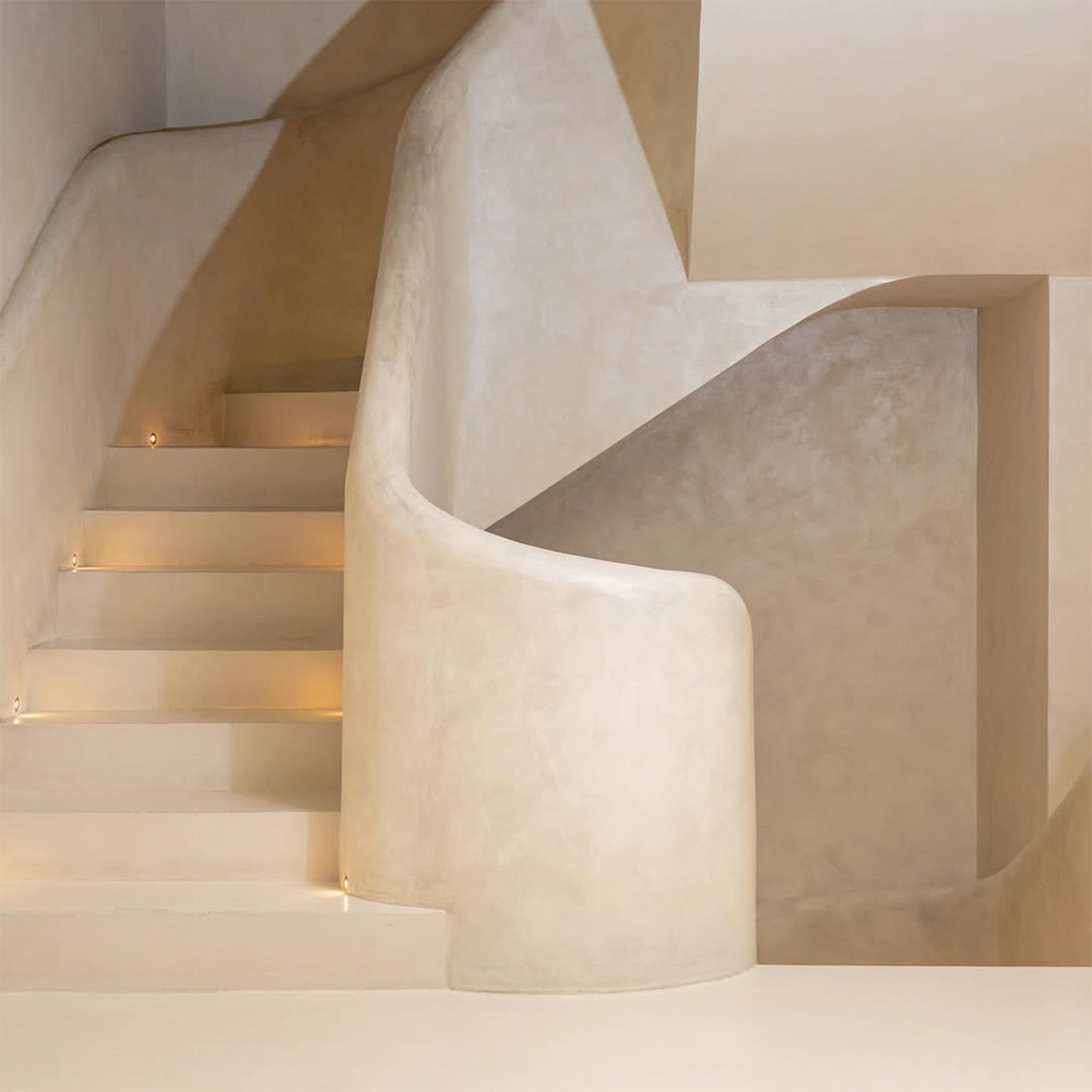 Curved staircase finished in seamless microcement at Lune Café Dubai