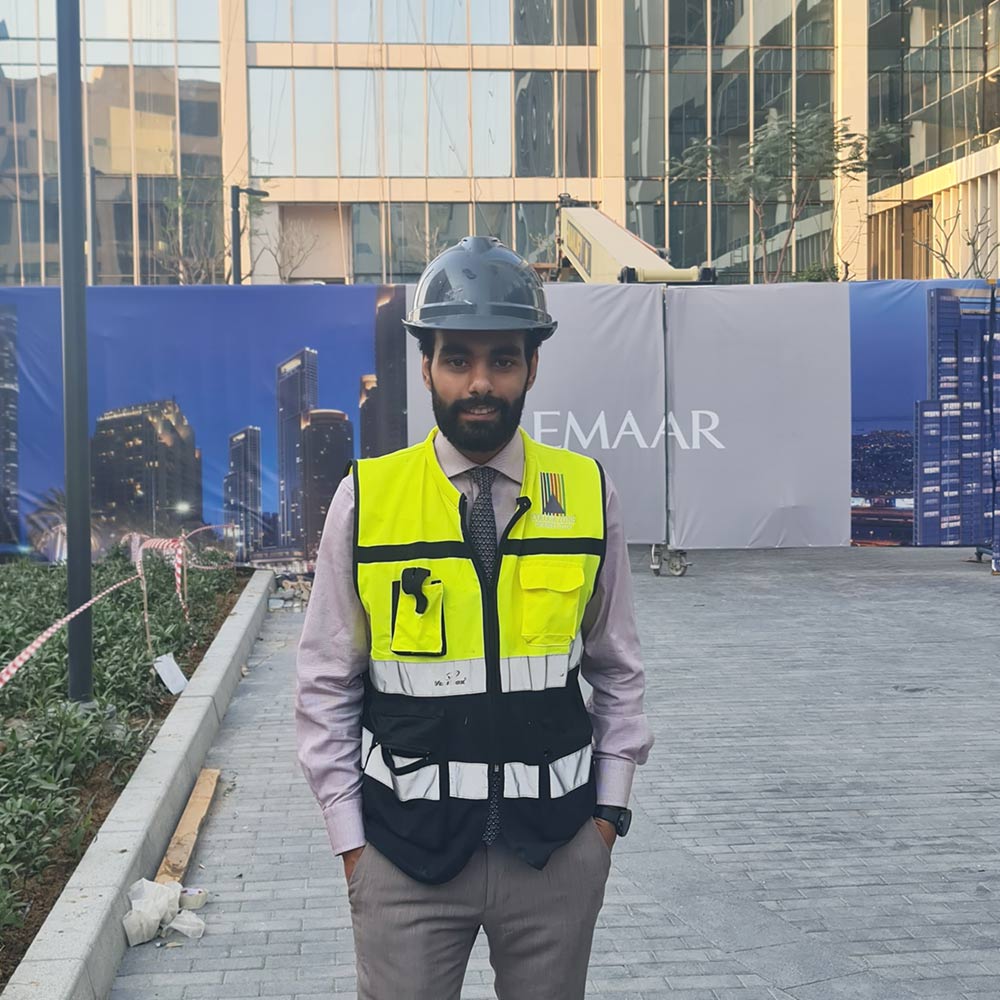 Project manager in safety gear supervising decorative finishes on Emaar construction site in Dubai