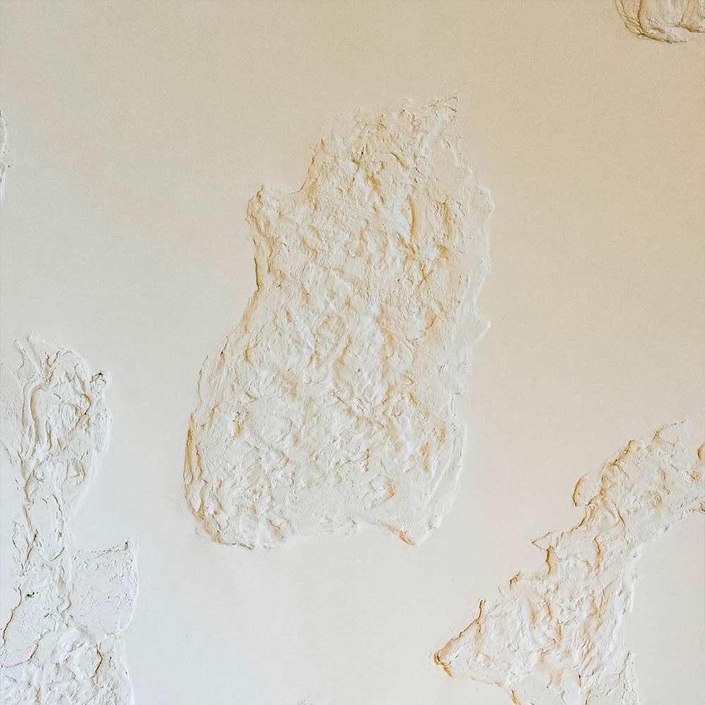 Textured decorative wall paint in beige at Lune Café Dubai