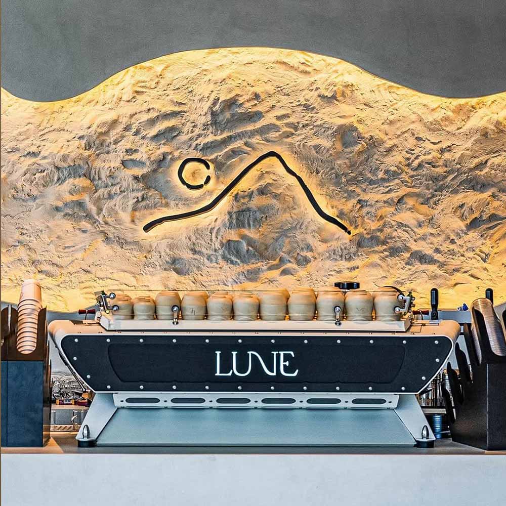Stone-effect decorative plaster finish at Lune Café Dubai
