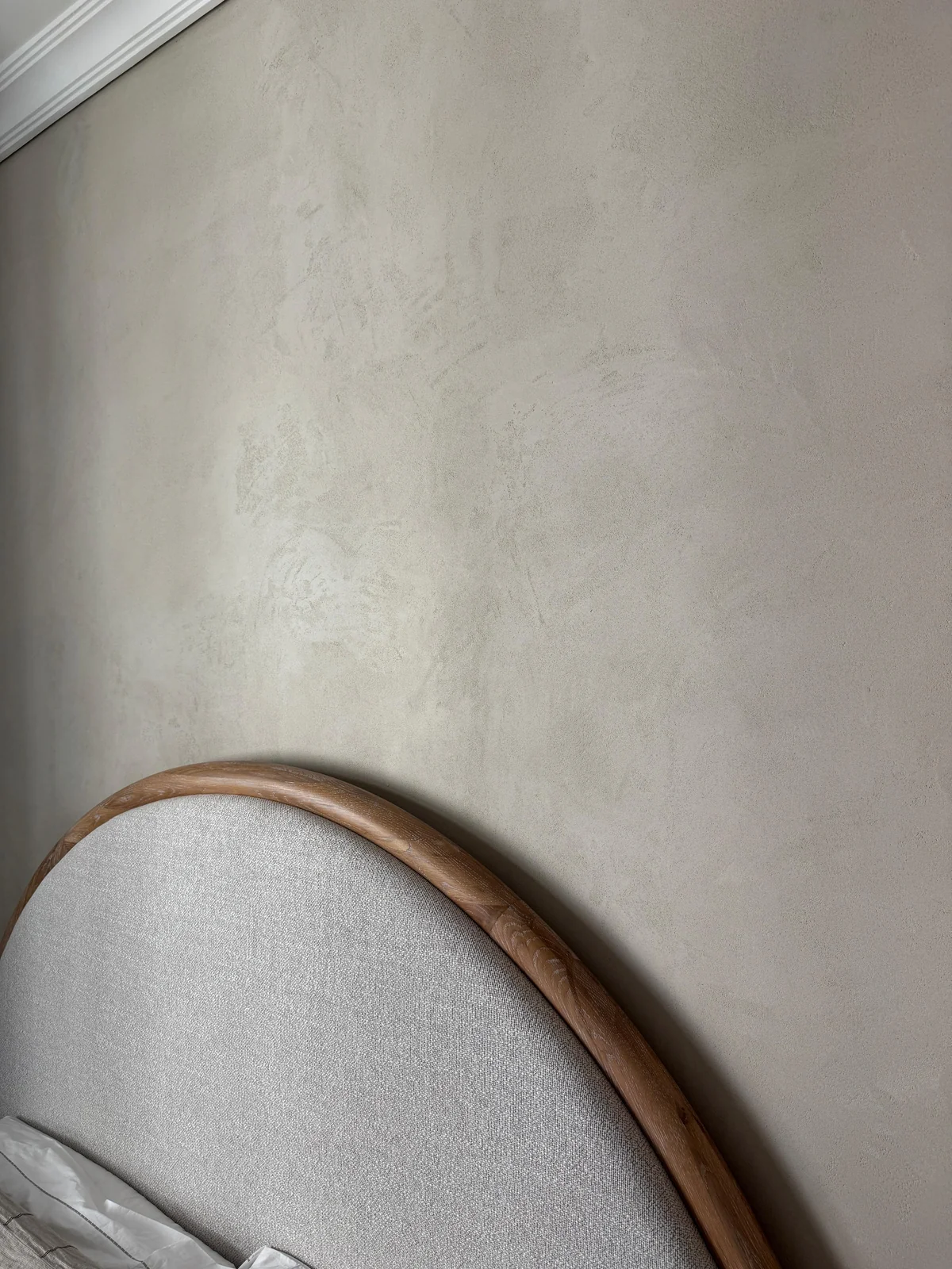 Soft mineral texture beside a curved handrail