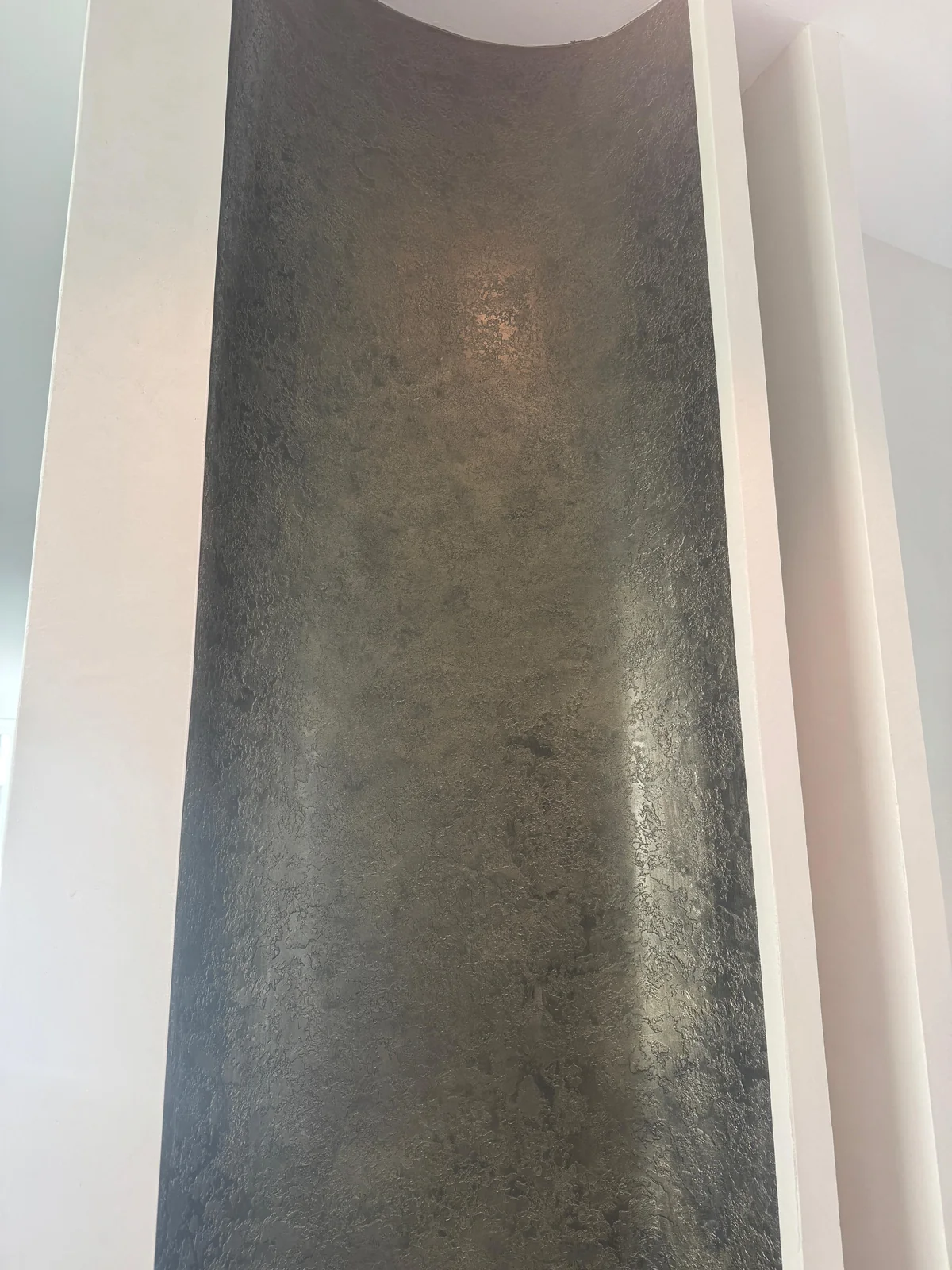 Dark tonal texture within a recessed wall panel