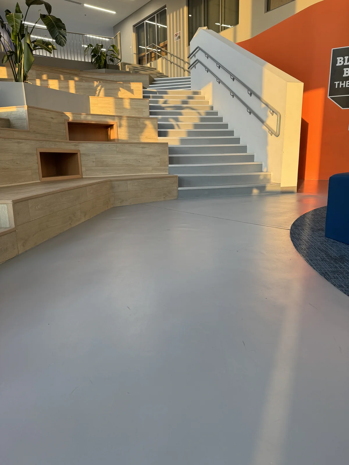 Microcement flooring at the foot of a feature staircase