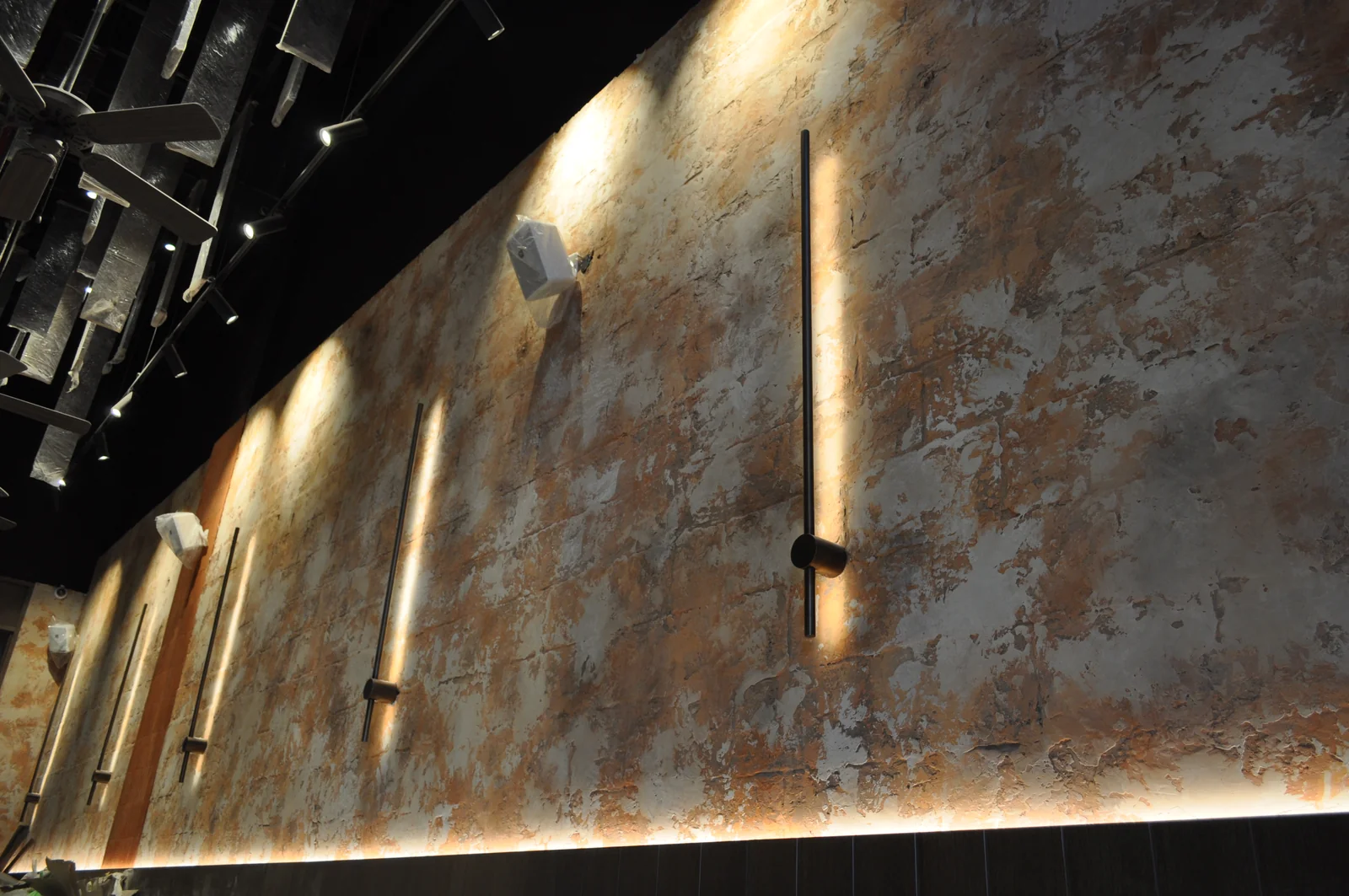 Layered rustic wall texture with warm accent lighting