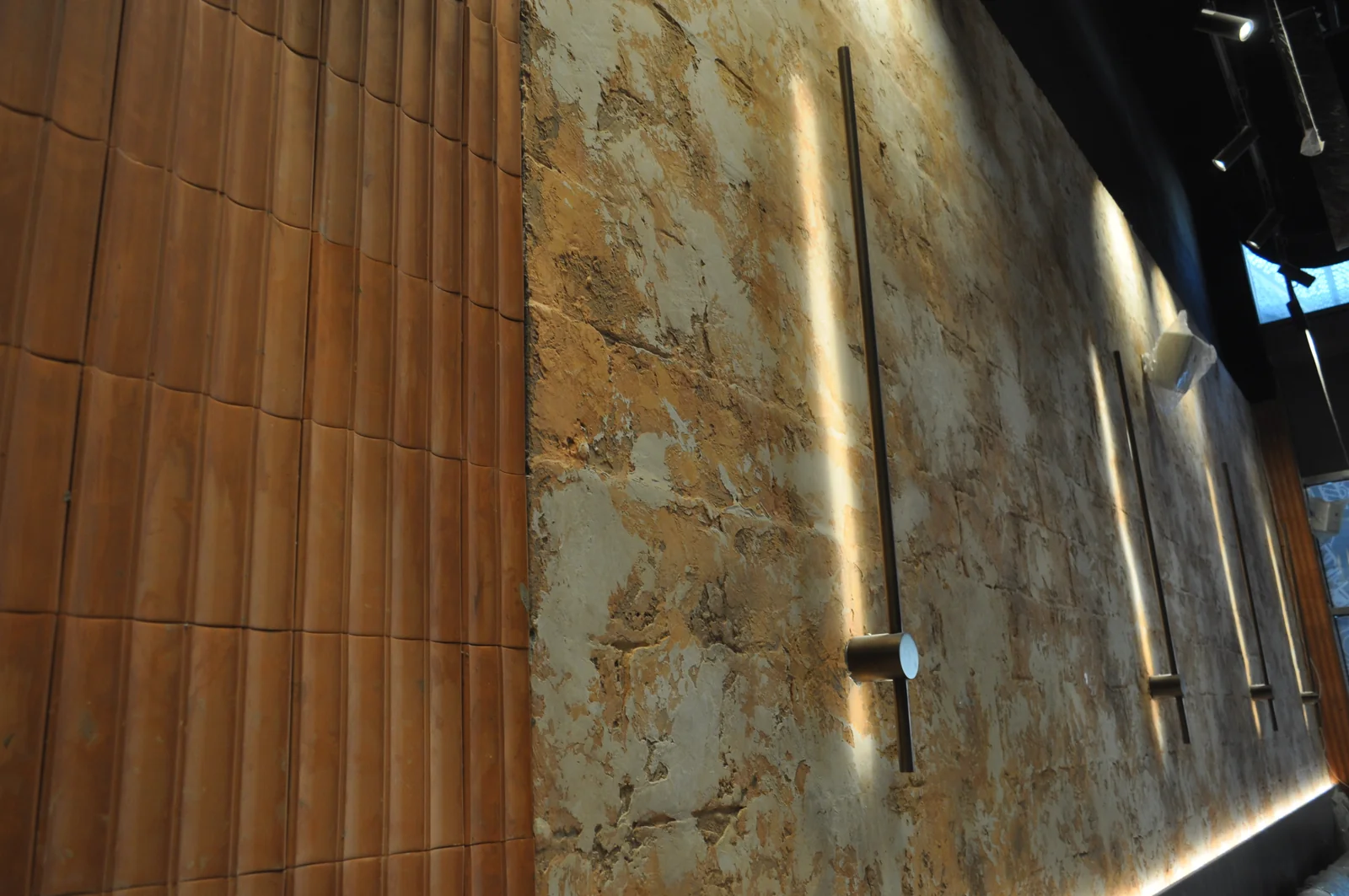 Close-up of an aged plaster effect beside timber detailing