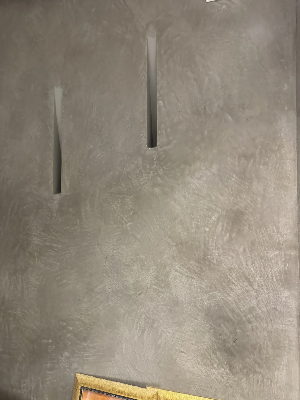 Tadelakt-inspired grey finish with recessed wall details