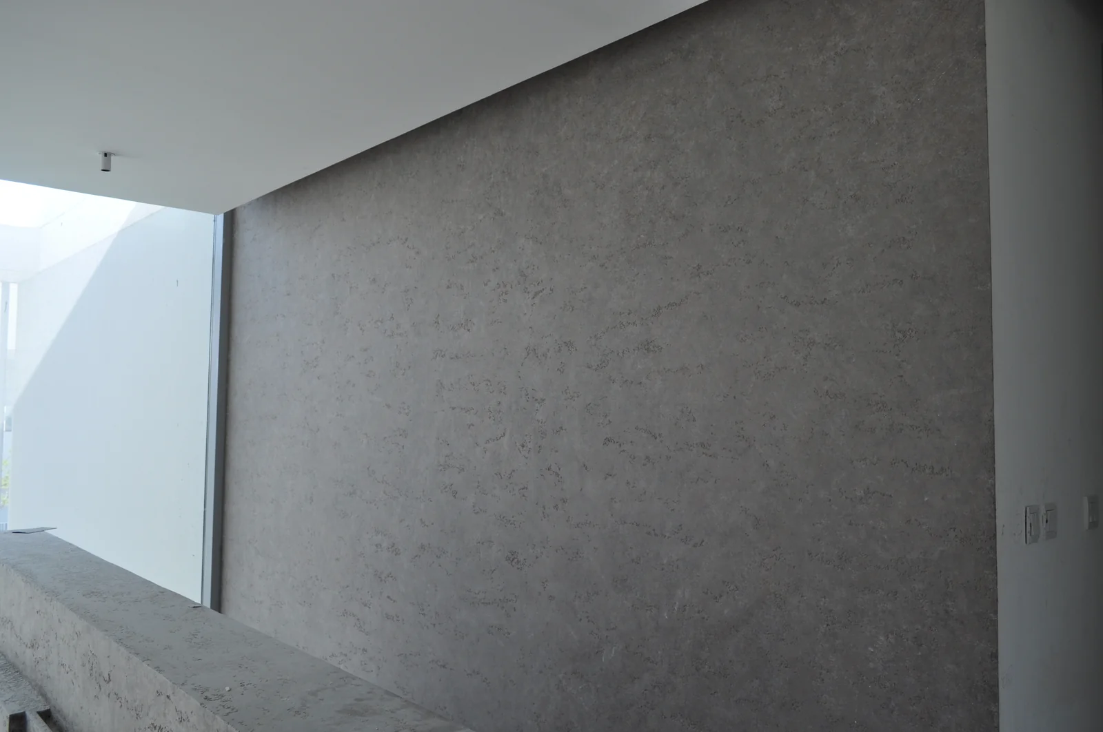 Continuous stone-inspired texture along a feature wall