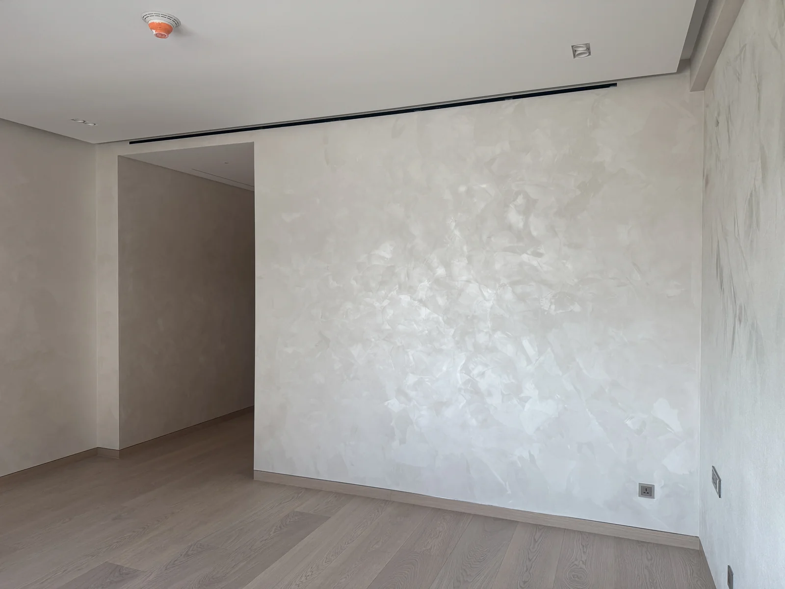 Light-responsive velvet finish across a full feature wall