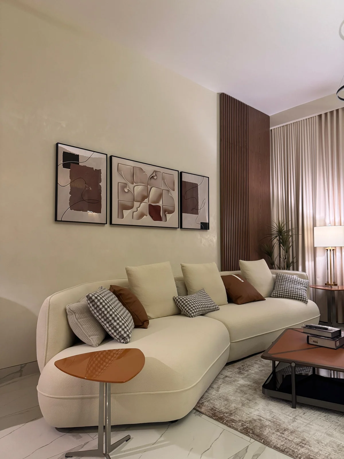 Soft tonal stucco backdrop behind a curved sofa