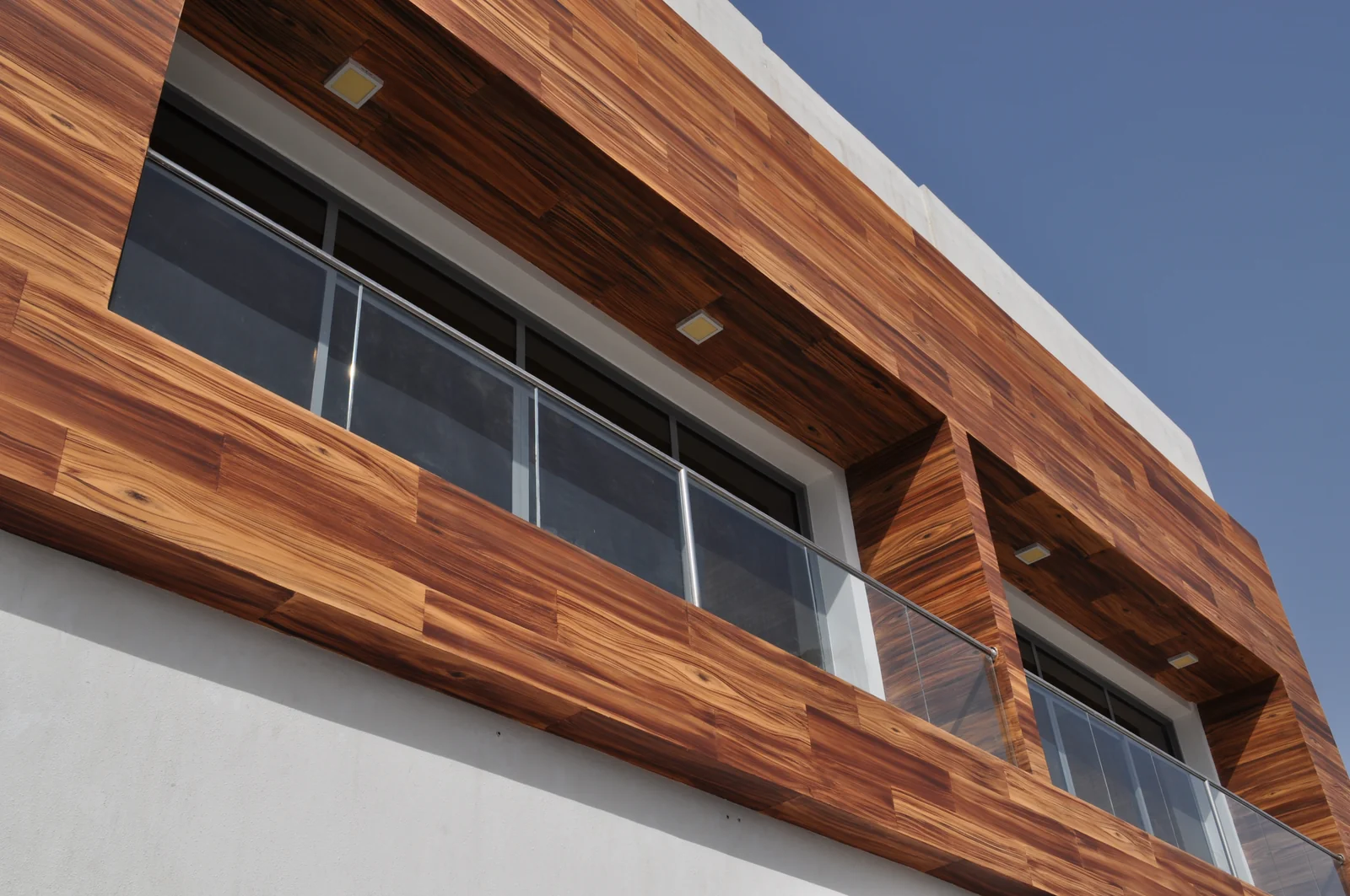 Wood-imitation finish framing a building façade